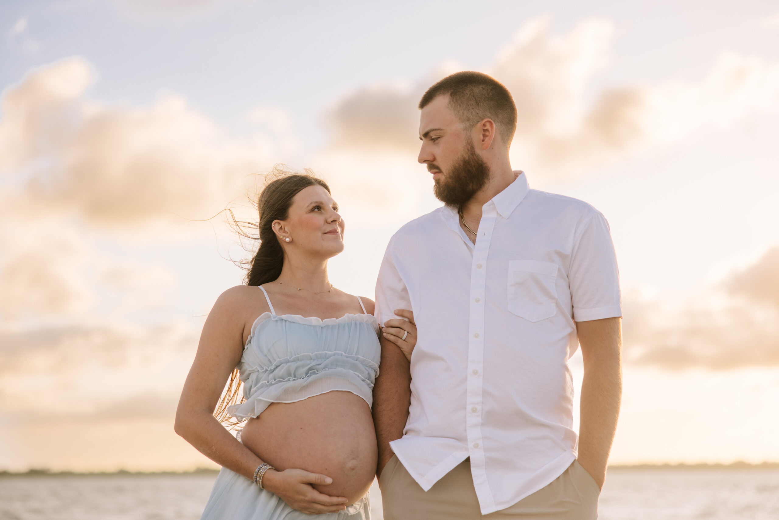 Couple Maternity Photos on the beach with the sunset